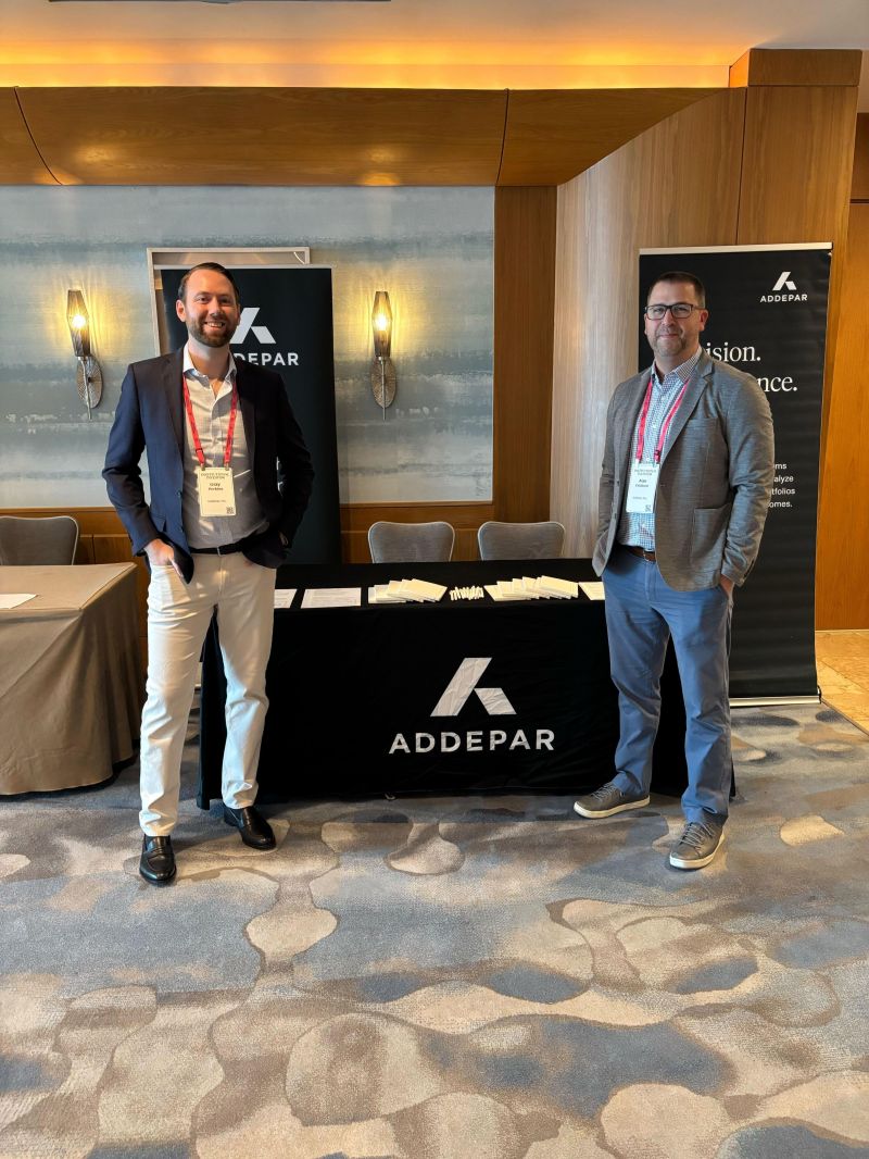 Two Addepar representatives at an Institutional Investor tabletop exhibit